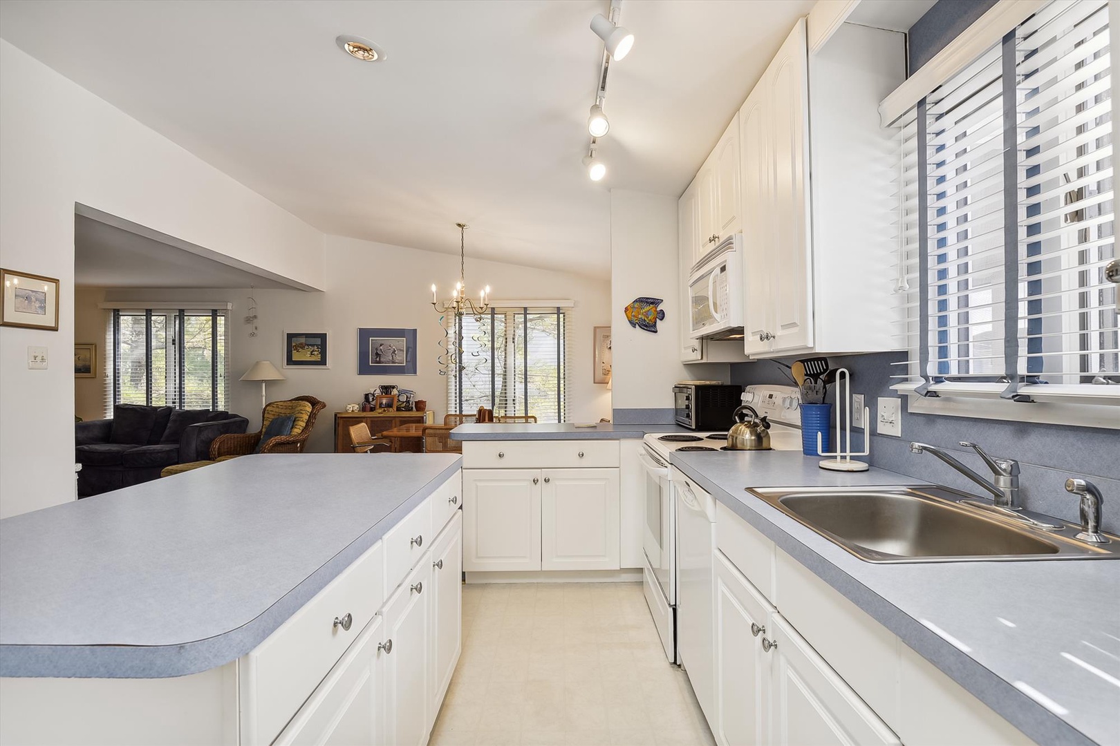 Picture yourself preparing meals in this bright, fully equipped kitchen with ample counter space, modern appliances, and an open flow into the cozy living area where you can unwind.