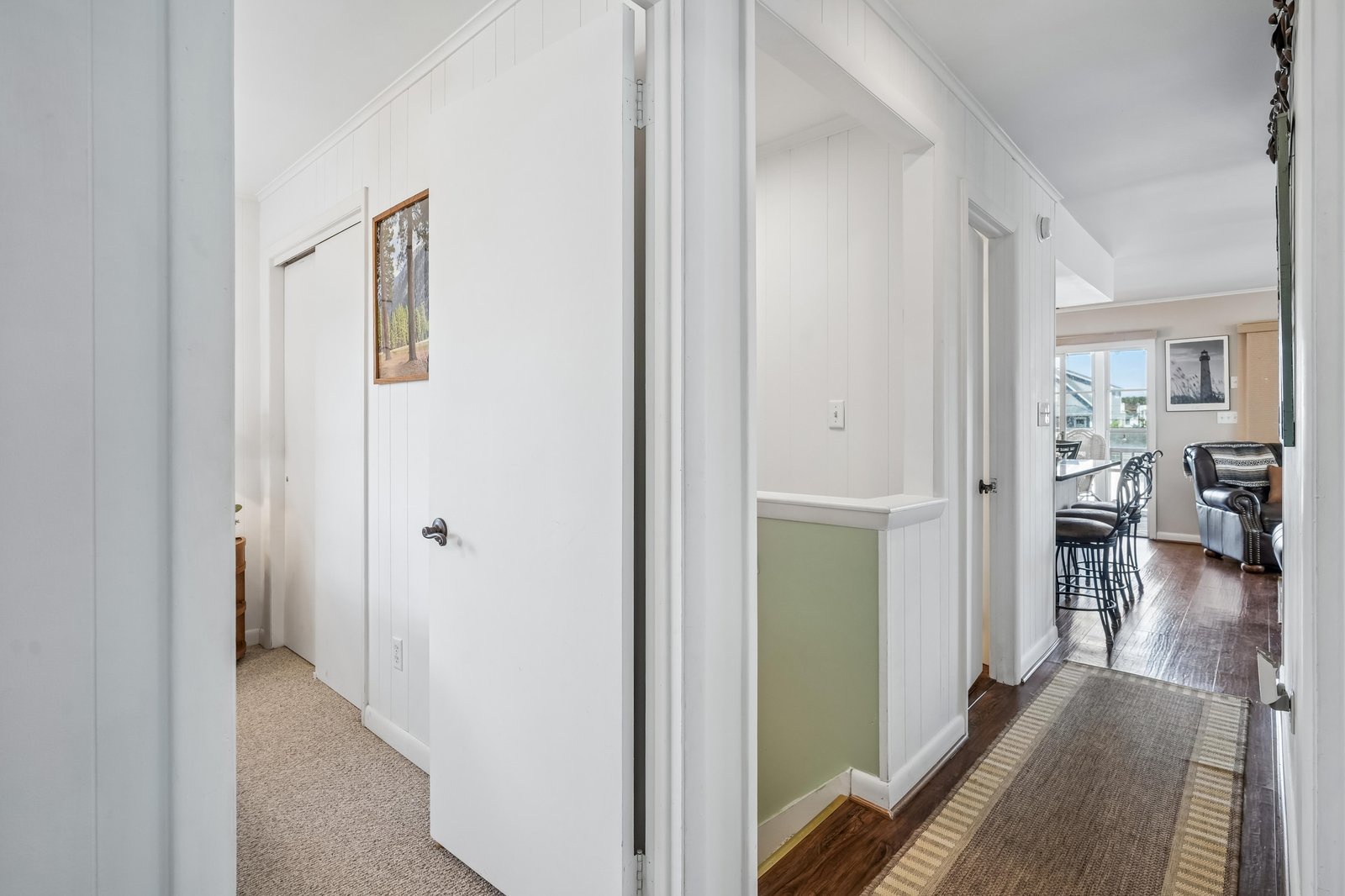 This bright hallway welcomes you into your retreat, connecting cozy bedrooms to a spacious living area where you can unwind, cook, and enjoy your getaway.