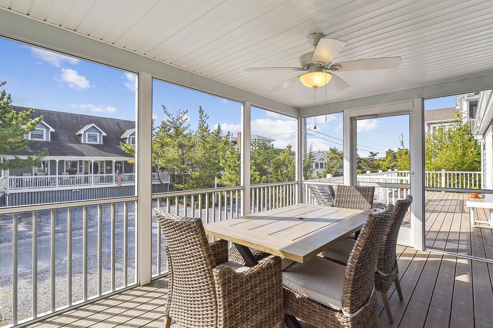 Your screened porch overlooks calm waterfront views, where you can dine outdoors and enjoy gentle breezes beneath the ceiling fan, creating your perfect retreat any time of day.