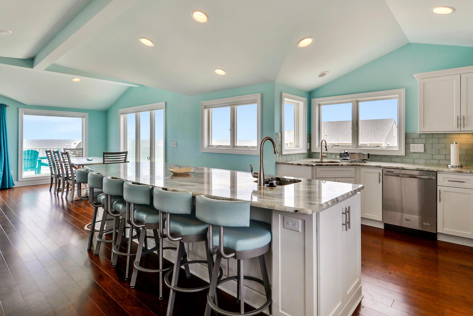Gather around your spacious island with ocean views through every window. Bright turquoise walls and gleaming hardwood floors set the stage for unforgettable meals and easy conversation.