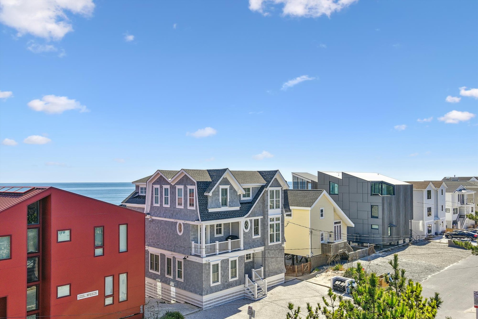 A coastal vacation rental community featuring colorful beach houses with ocean views, offering a classic seaside getaway experience.