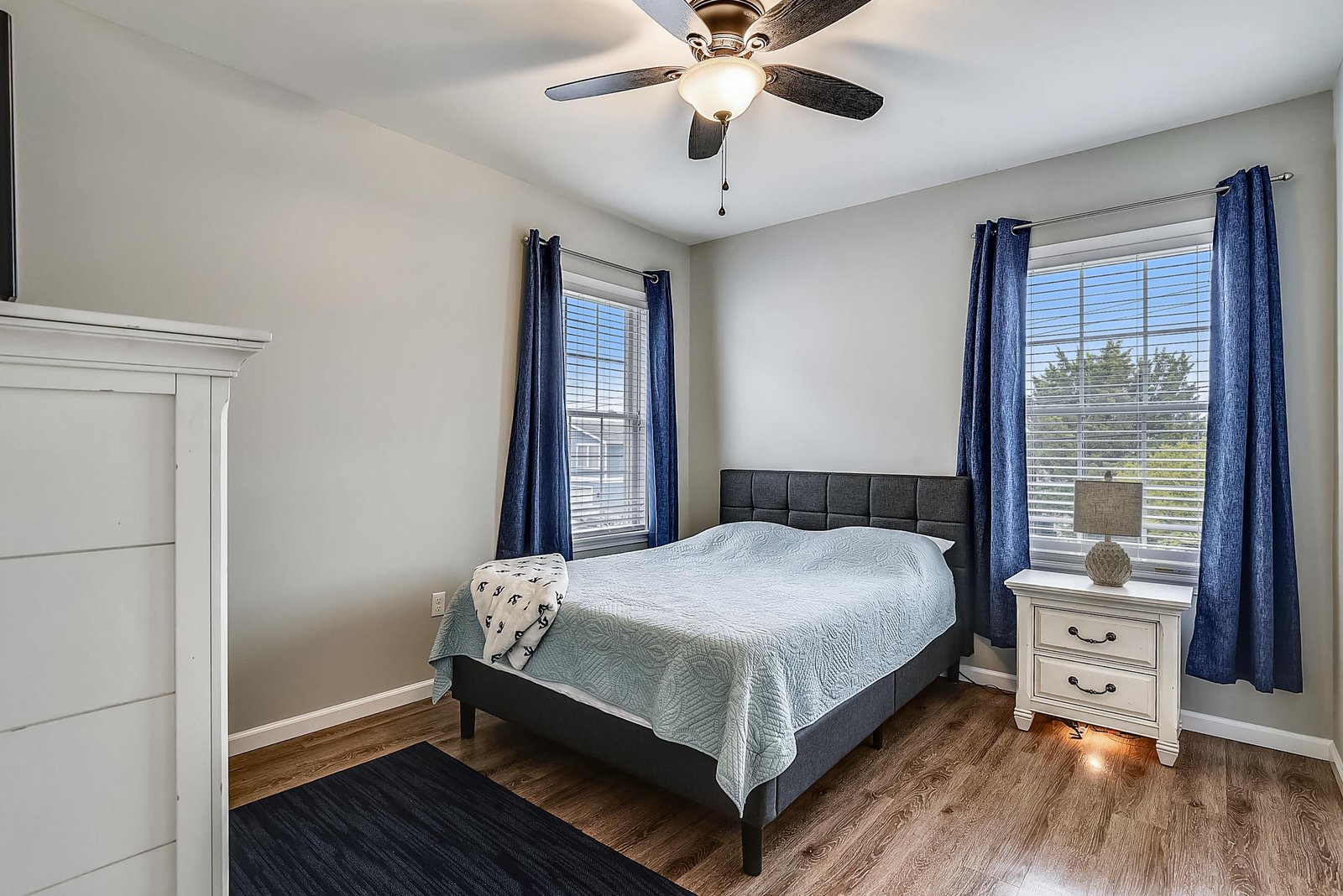 Rest and recharge in your peaceful bedroom, where soft linens, natural light, and a ceiling fan invite restful nights and lazy mornings.