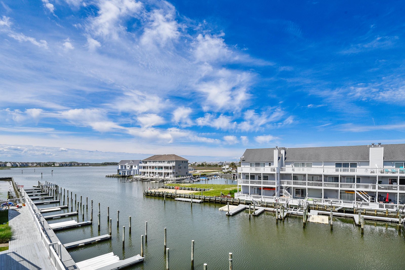 Waterfront community with private boat slips, open water, and dramatic coastal skies—your perfect backdrop for peaceful mornings and easy access to adventure.