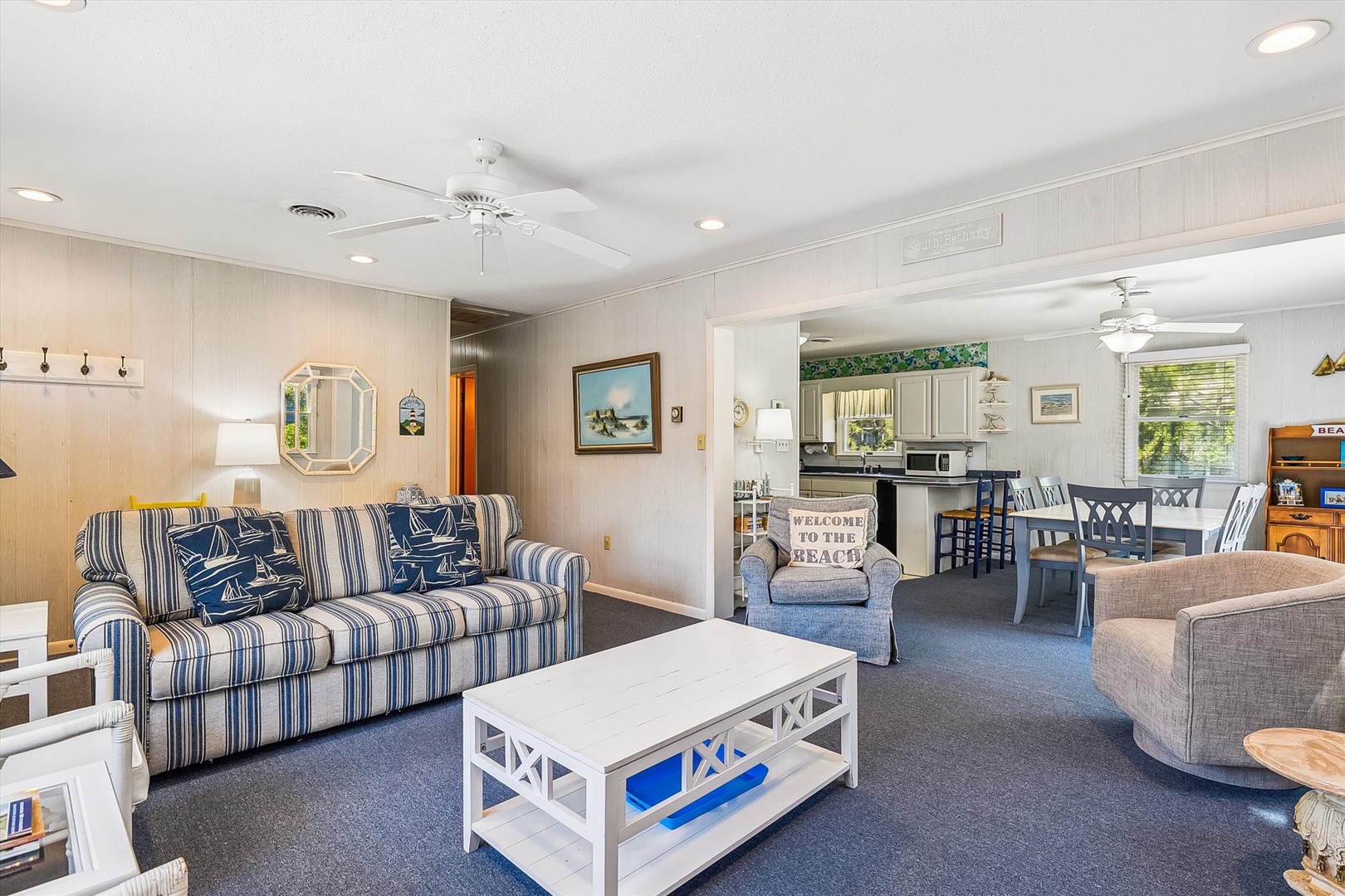 Settle into your coastal retreat—crisp blue stripes, nautical charm, and open-concept comfort invite you to unwind after sun-soaked days by the shore.
