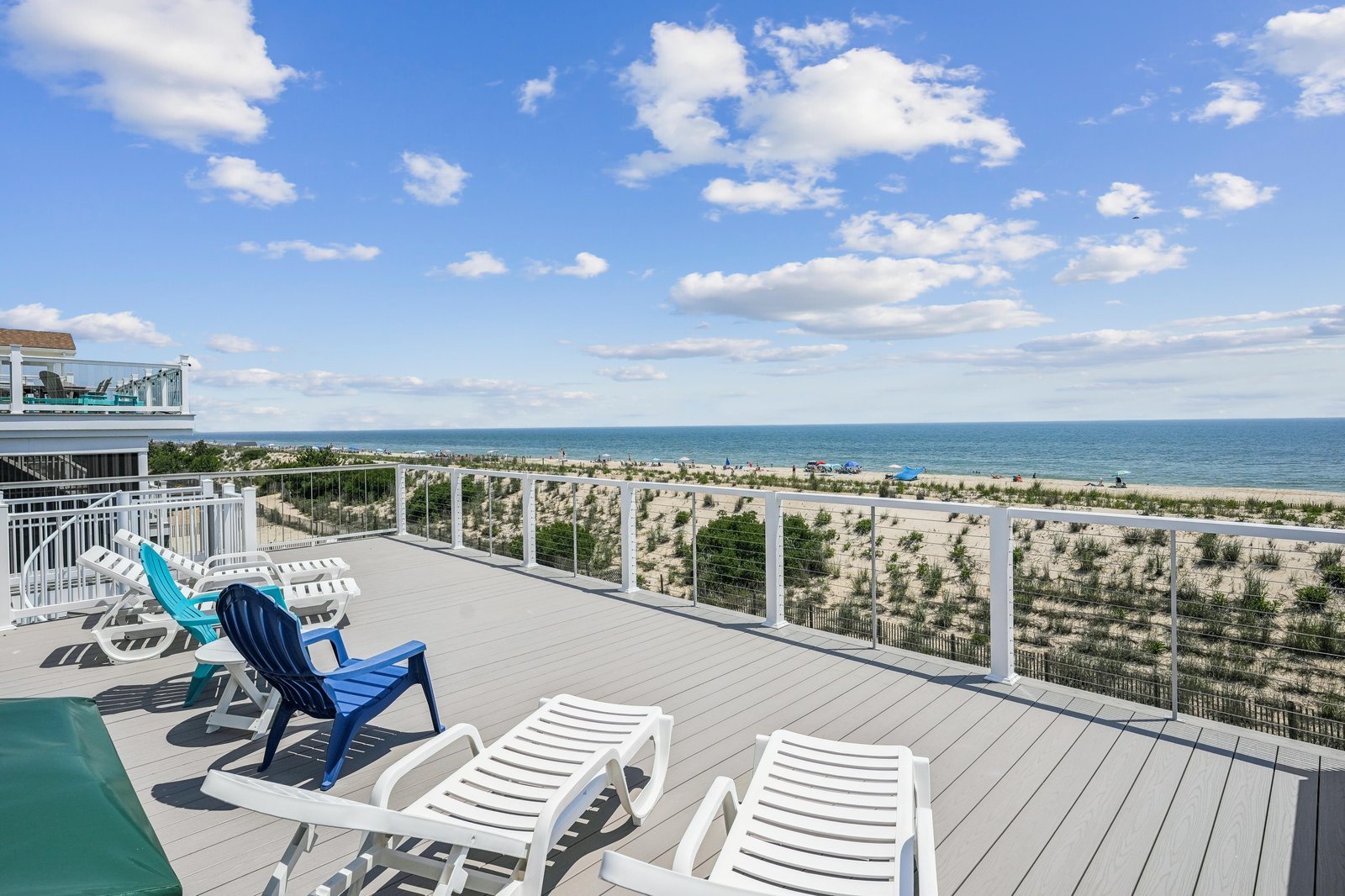 This spacious oceanfront deck overlooks sweeping views of the beach and sparkling Atlantic waters. Stretch out on a lounge chair, soak up the sun, and let the coastal breeze melt your worries away.