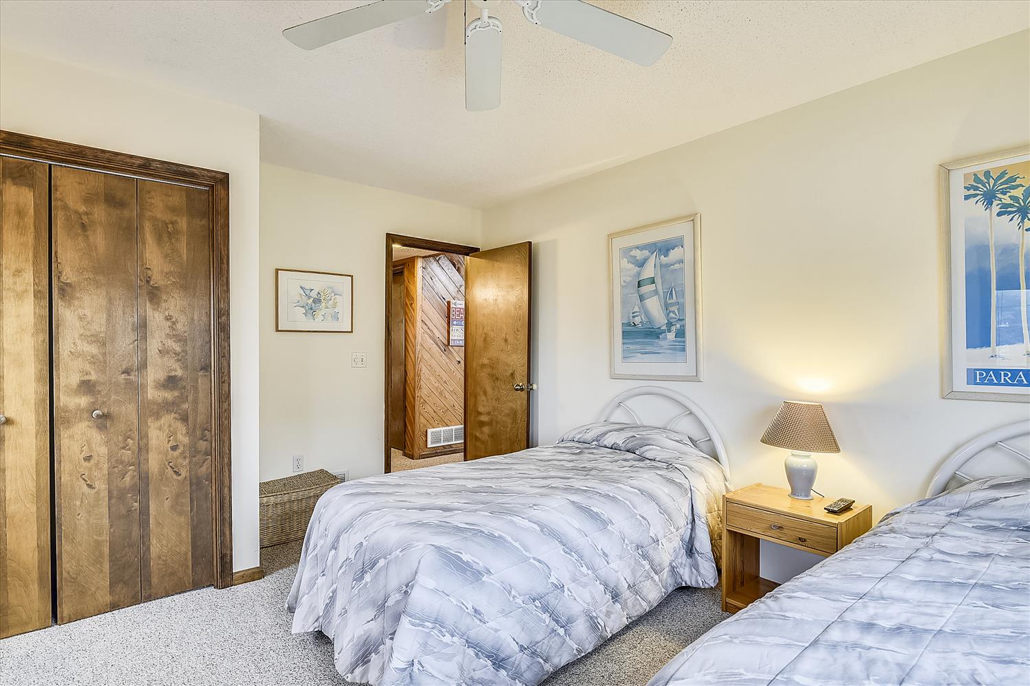 Two cozy beds await your restful nights in this bright, welcoming bedroom with thoughtful furnishings and coastal charm—perfect for families or friends sharing a peaceful getaway.