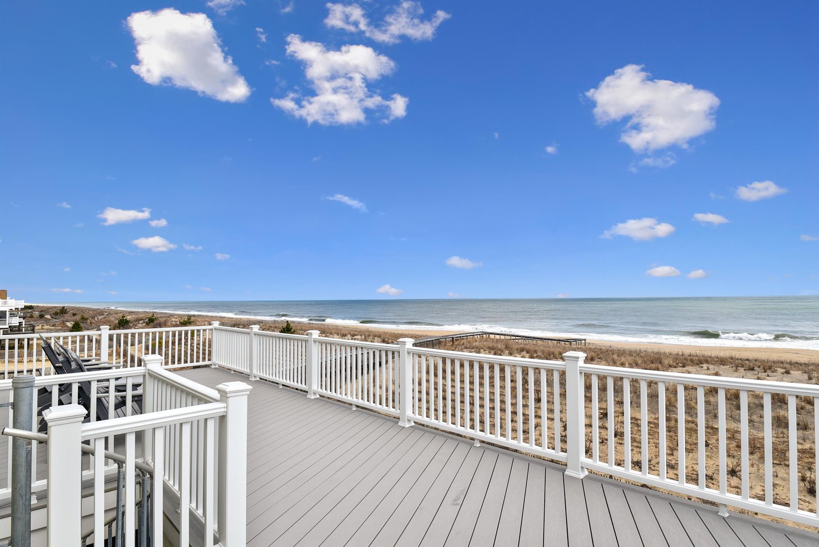 This spacious deck offers unobstructed ocean views stretching across the horizon. Relax in comfortable seating as the sea breeze and sound of waves create your perfect coastal retreat.