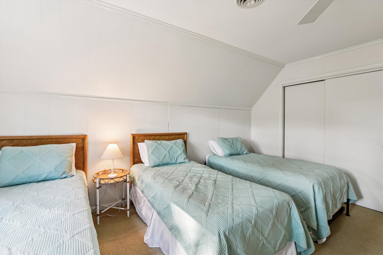 Rest peacefully in your cozy twin bedroom, where soft mint bedding and warm lighting create the perfect retreat after your adventures.