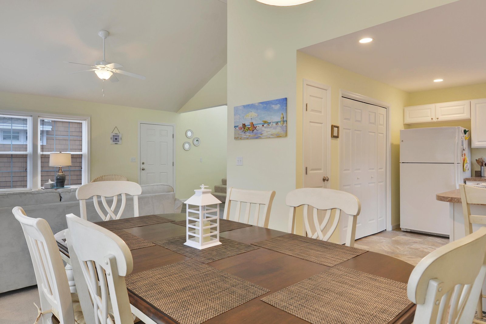 Gather around this inviting dining space, where high ceilings and soft natural light create a warm, open atmosphere for your morning coffee or evening meals.