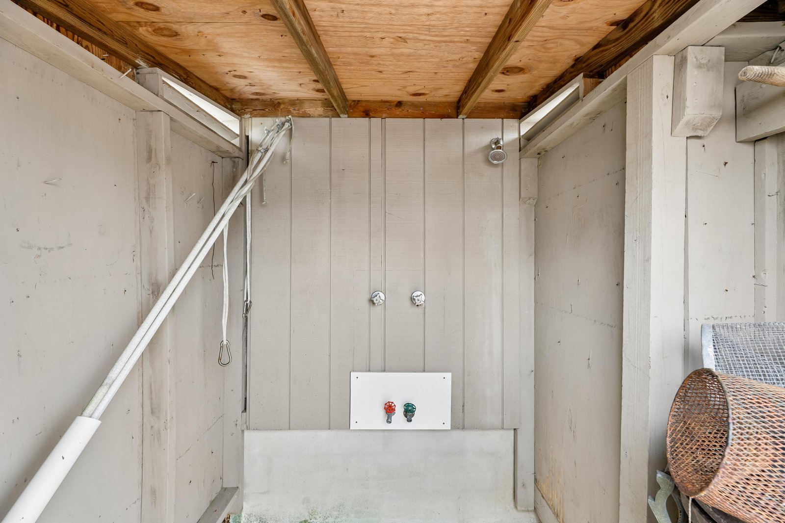 Rinse off under the open sky in your private outdoor shower, surrounded by natural wood and coastal charm.