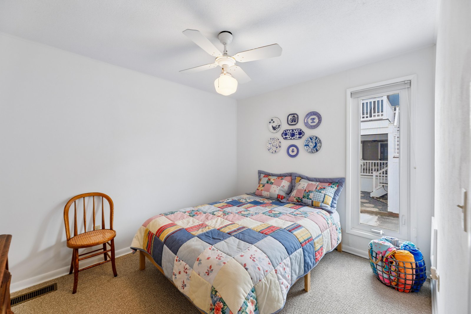 Settle in beneath a charming patchwork quilt, and let the gentle ceiling fan breeze lull you into vacation mode. Your private balcony access invites you to greet each coastal morning in comfort.