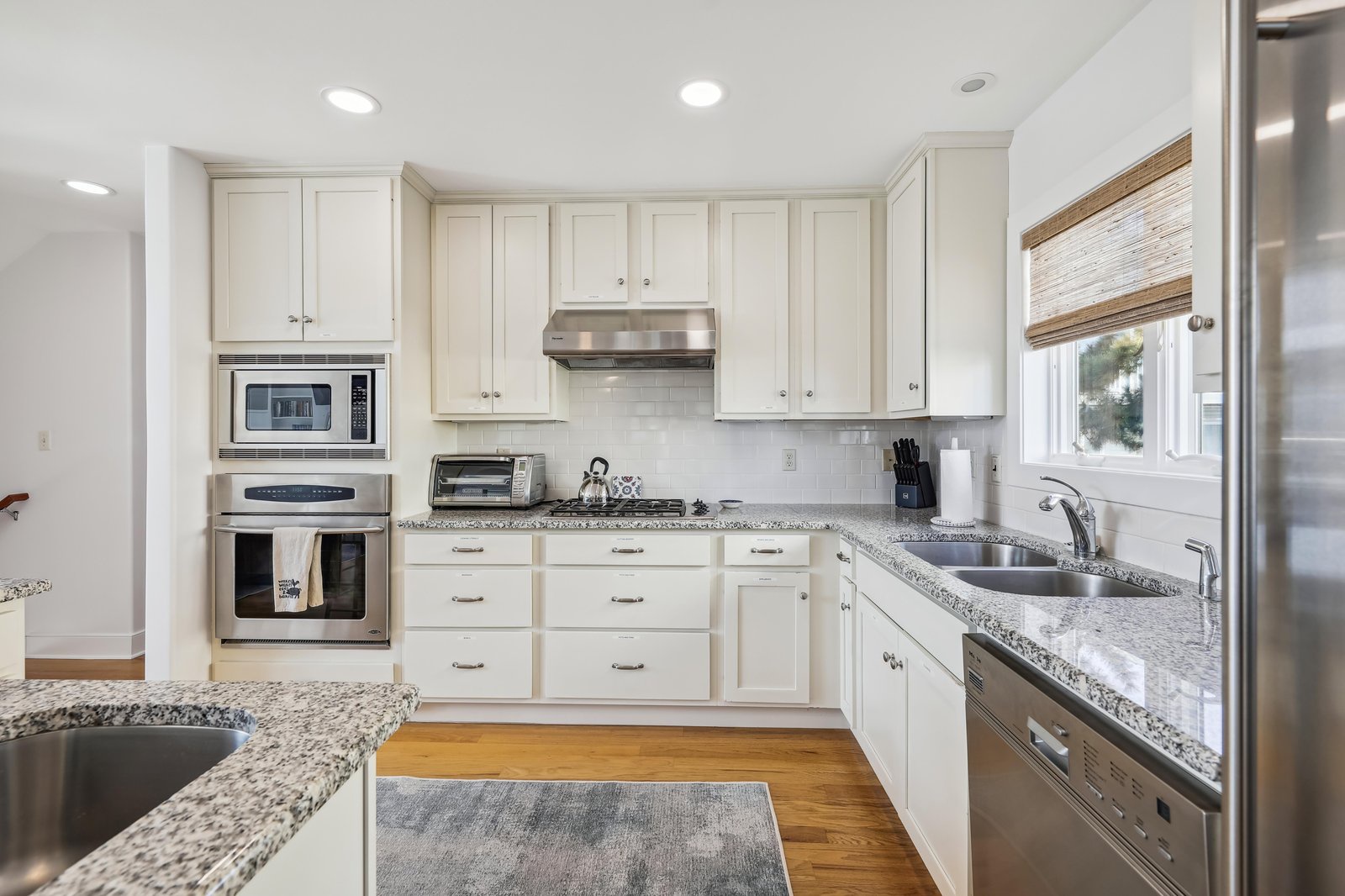 Your fully equipped kitchen with granite counters and stainless appliances makes meal prep easy, while the bright window and clean lines offer a fresh, welcoming space to cook and gather.