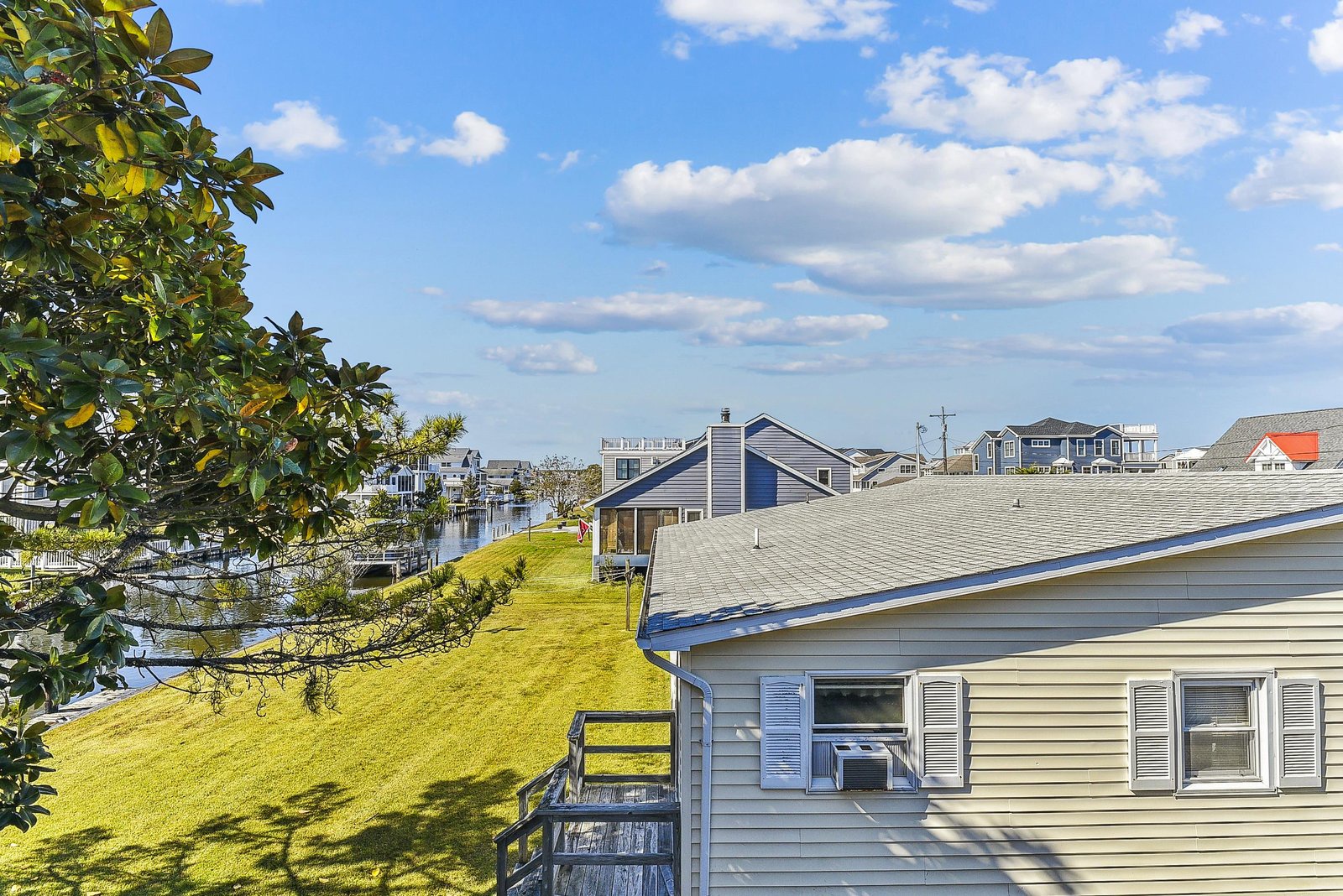 A peaceful waterside neighborhood where gentle canals and open skies meet green lawns. The property offers direct access to quiet waterways perfect for boating and enjoying coastal life.