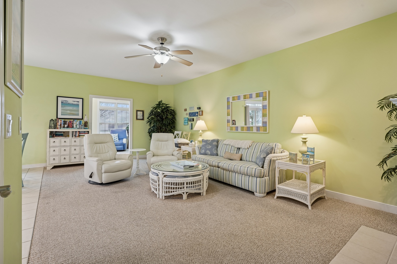 Unwind in your bright living space with soft seating, gentle ceiling fan breeze, and cheerful coastal colors that welcome you home.