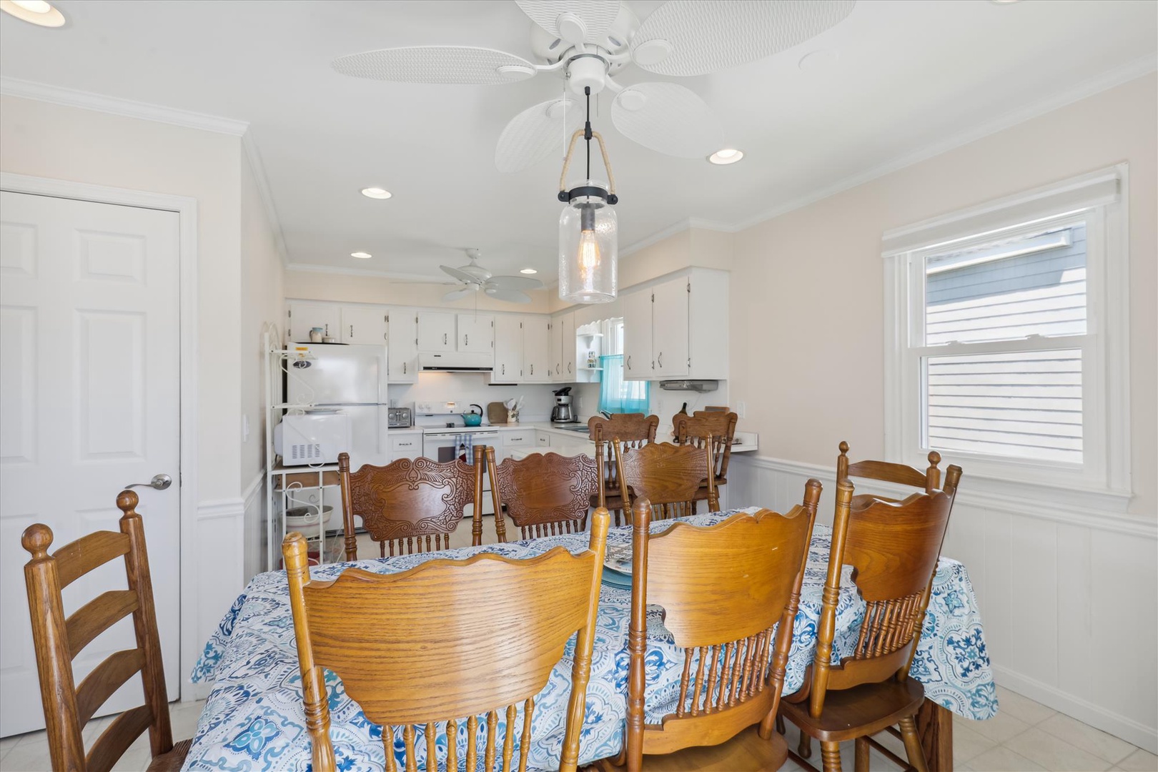 Gather around the large dining table with seating for everyone, just steps from your fully equipped kitchen—perfect for preparing and enjoying meals together.
