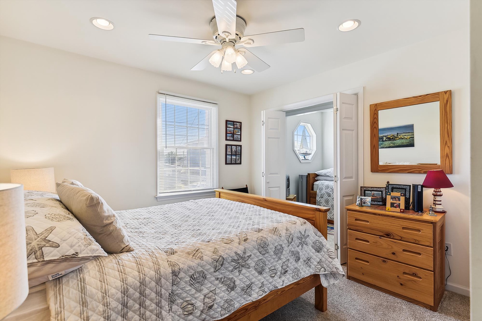 Drift off in your peaceful bedroom with coastal-inspired bedding, ceiling fan, and natural light welcoming you each morning.