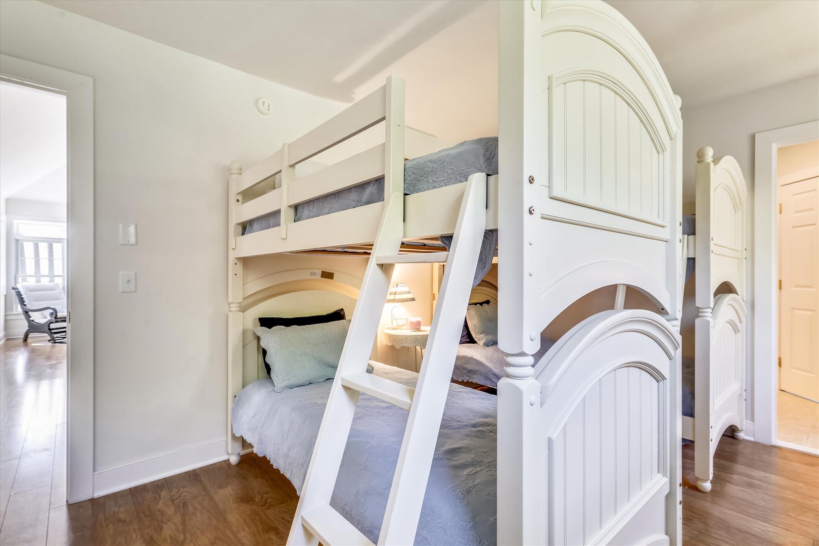 Climb into your own cozy bunk for a restful night. Crisp white linens, soft textures, and a peaceful bedroom setting make this space feel like home.