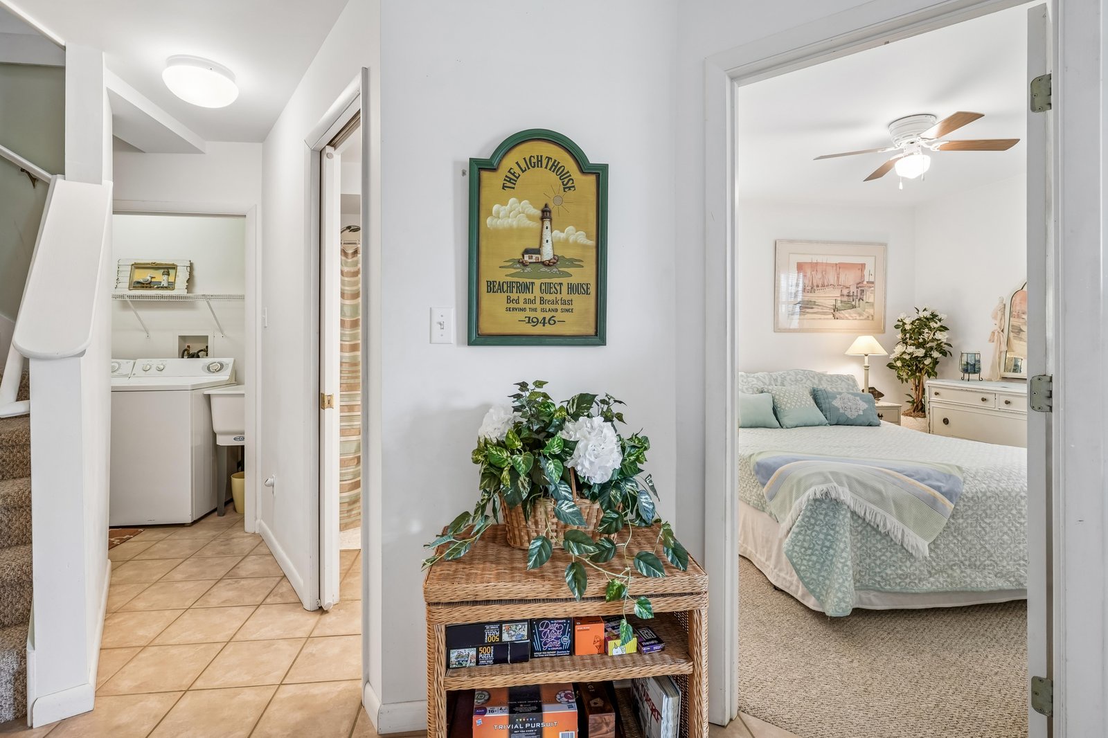 Step into your coastal retreat where beachy décor and thoughtful touches create an inviting sanctuary. The soft linens and ceiling fan promise restful nights after sun-soaked days.