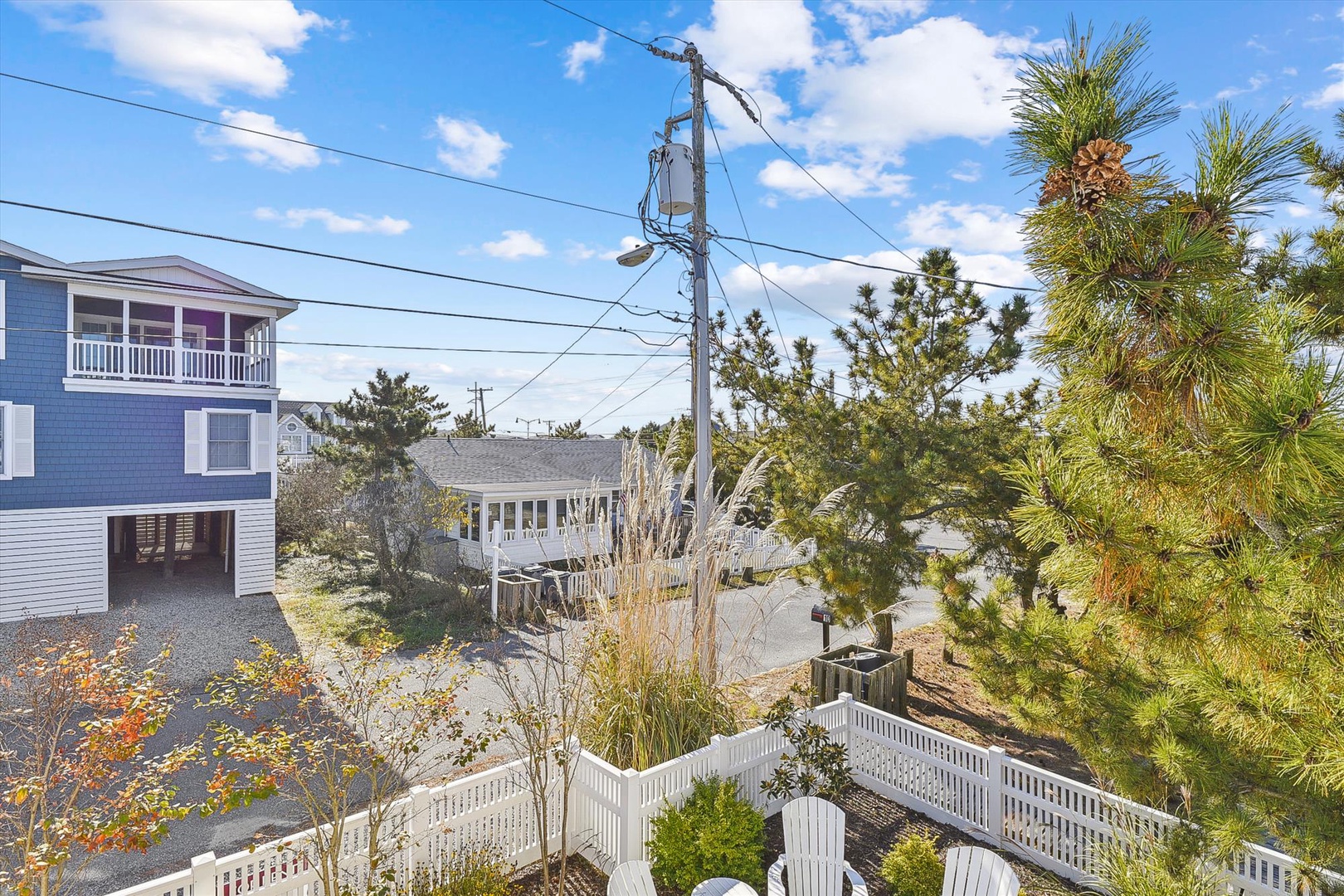This coastal neighborhood setting features residential properties with beachside vegetation, offering convenient access to vacation rental lodging near the shoreline.