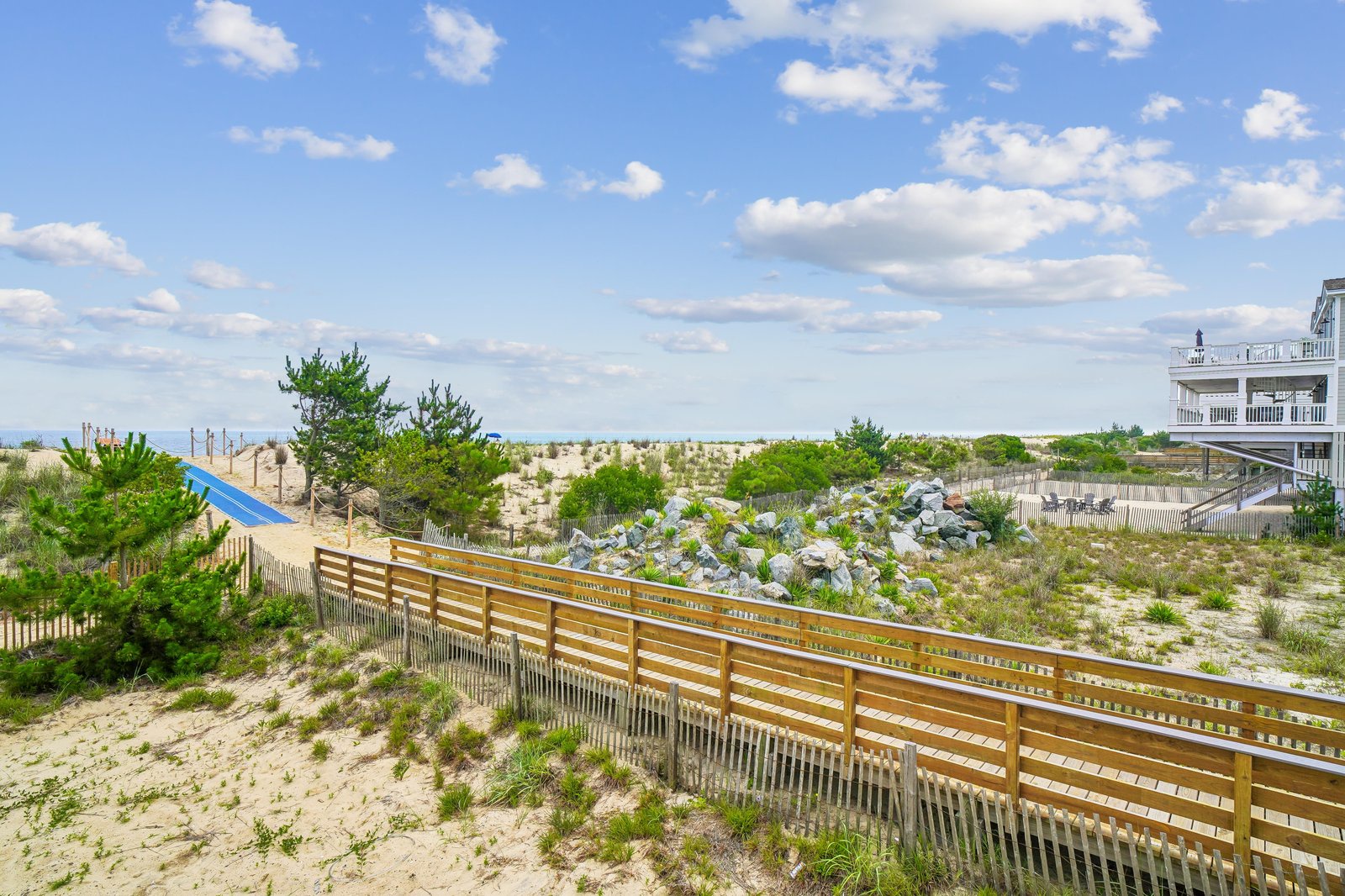 The property is situated in a peaceful coastal area with easy access to sandy dunes and scenic natural surroundings.