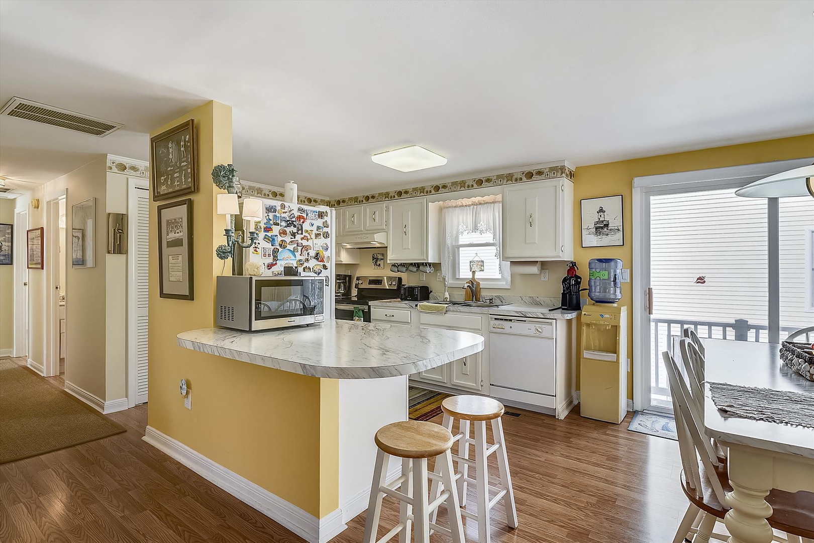 Your spacious kitchen invites you to cook, gather, and share stories, with modern appliances, marble countertops, and a cheerful breakfast bar for morning coffee or late-night snacks.