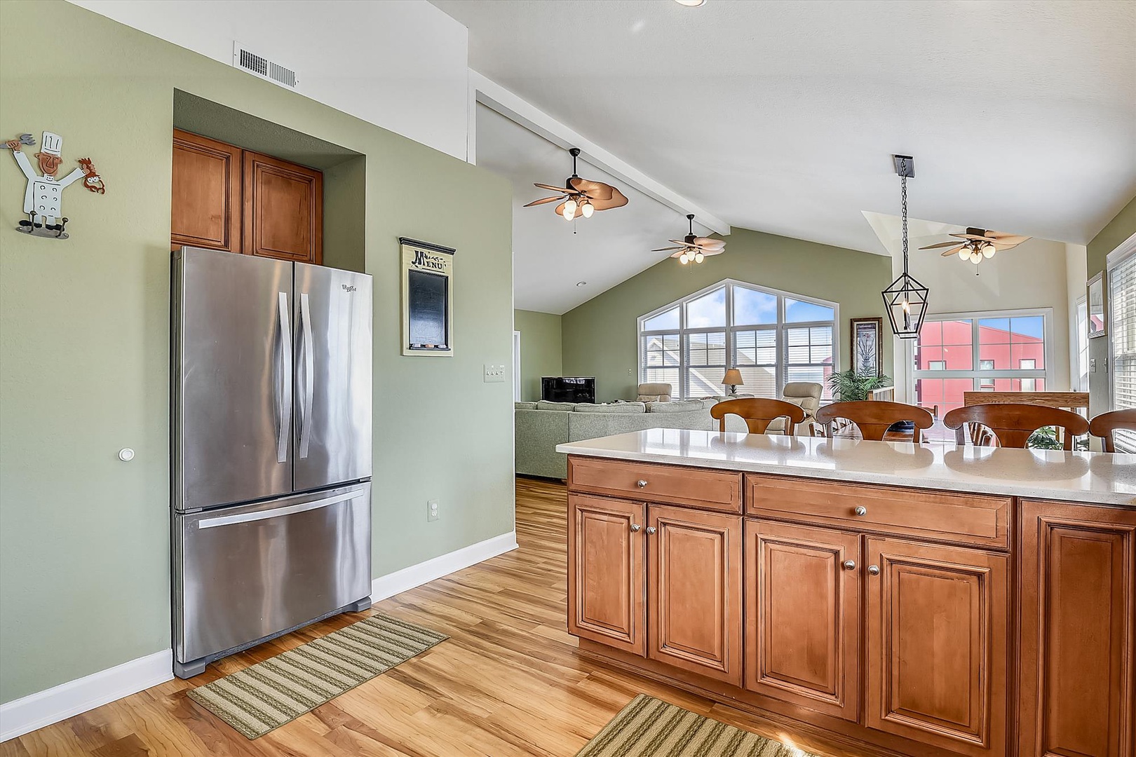 Your spacious kitchen flows seamlessly into the dining area, featuring warm wood cabinets and stainless steel appliances for all your culinary adventures.