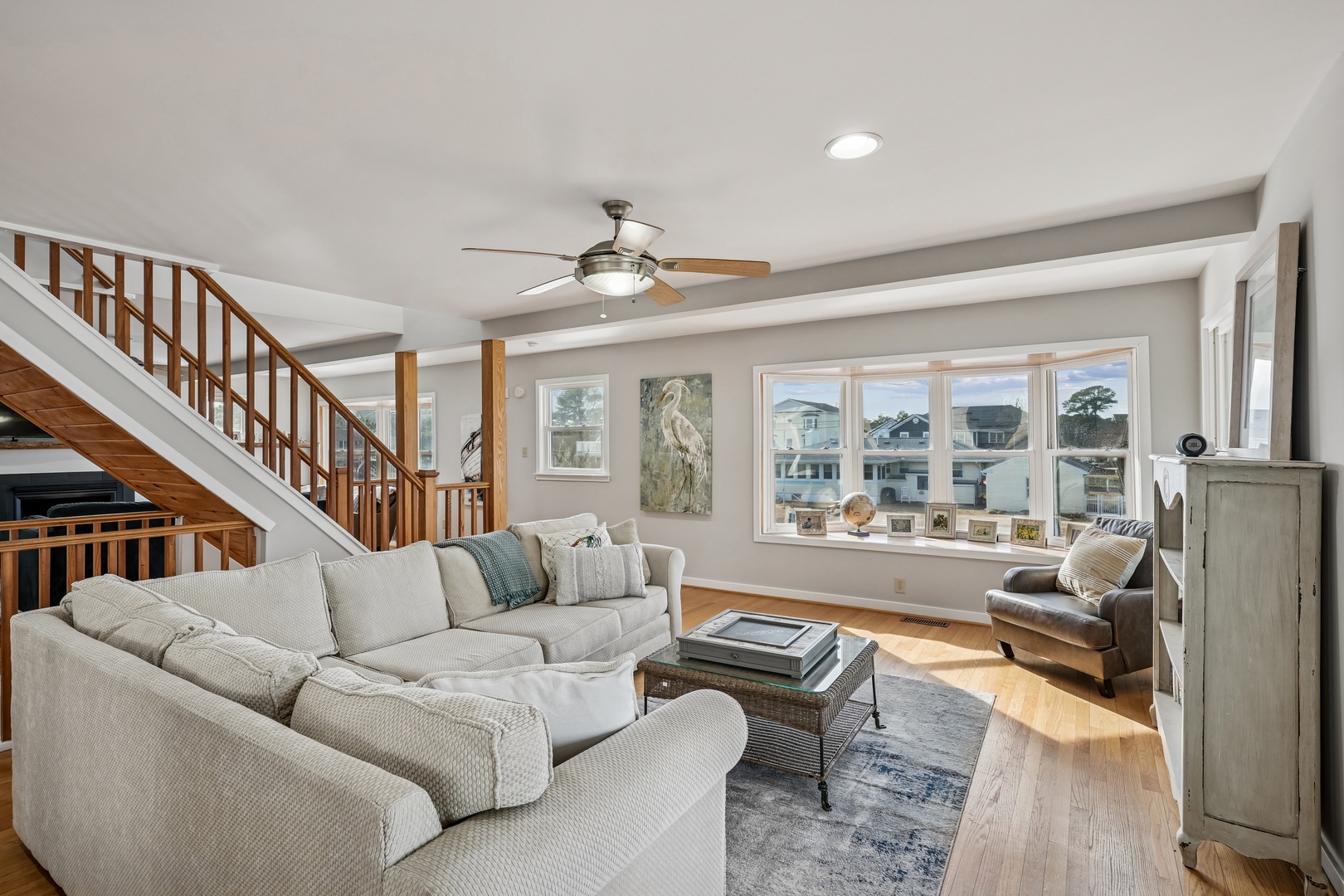 Relax in this bright, airy living room where plush sofas and coastal views create your perfect retreat sanctuary.