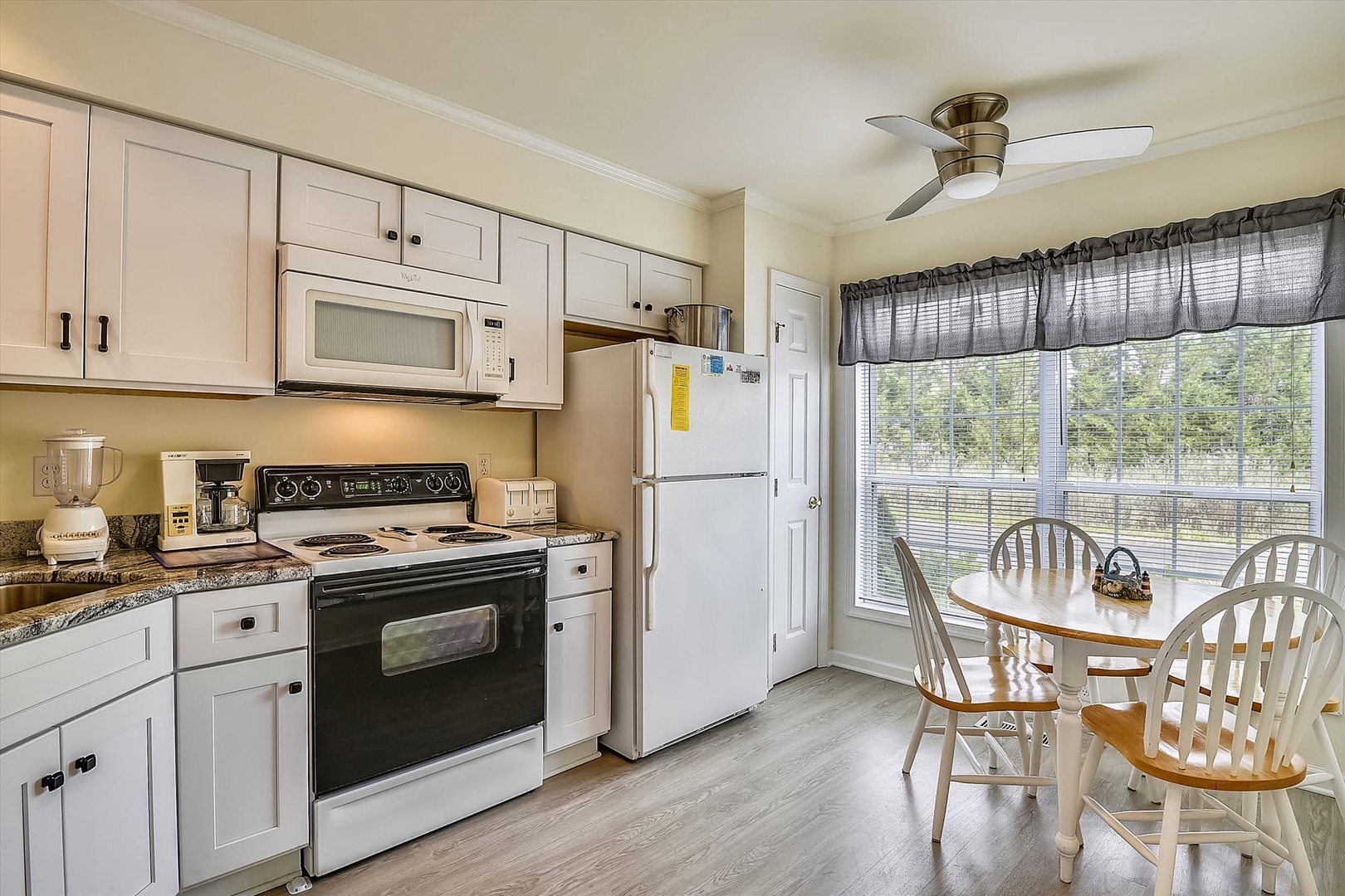 Your fully equipped kitchen has everything you need to prepare meals, with modern appliances, ample counter space, and a cozy dining nook overlooking lush greenery.