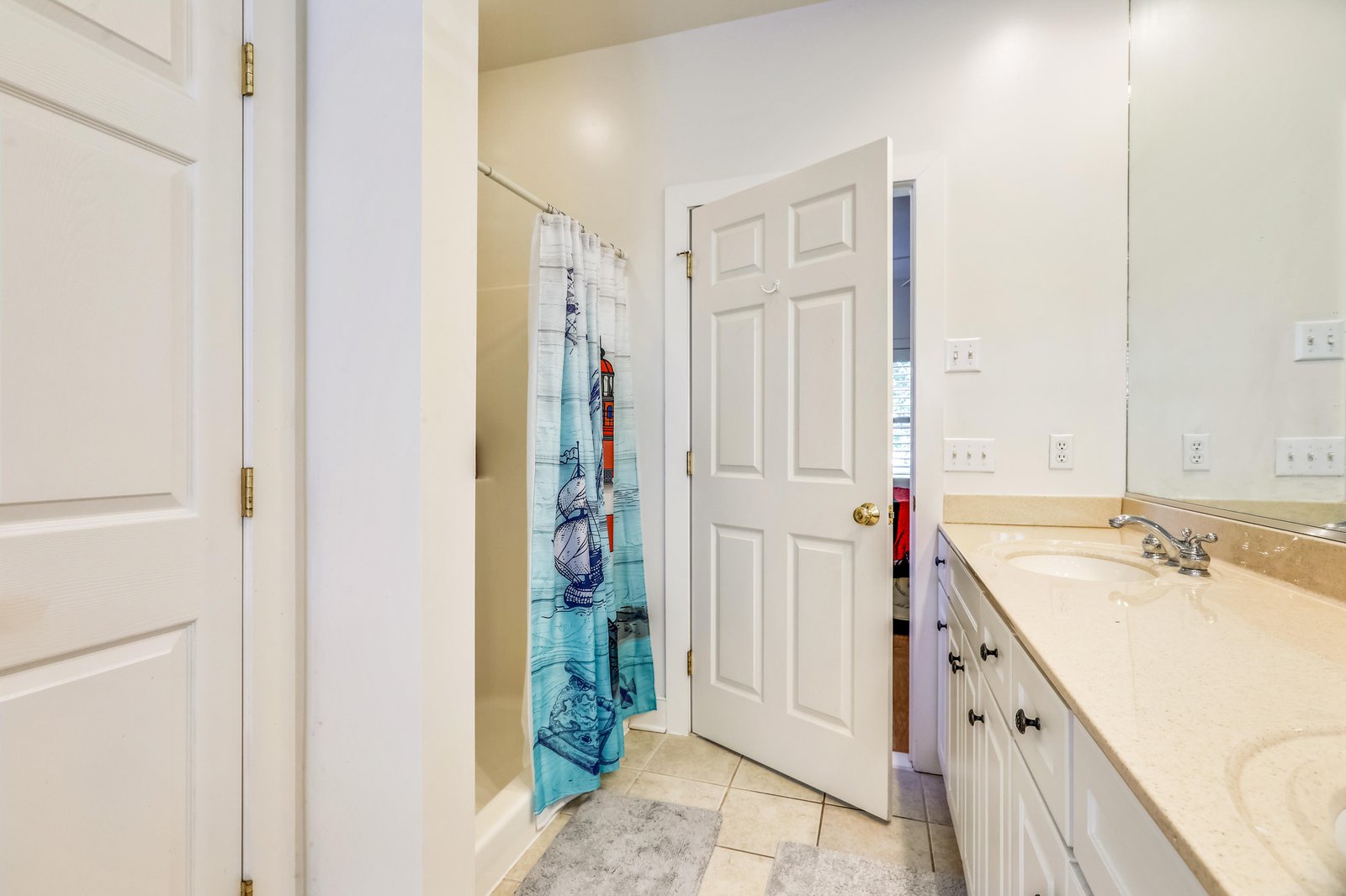 Step into your private bathroom with fresh towels, a roomy vanity, and plenty of storage to keep your essentials close at hand.