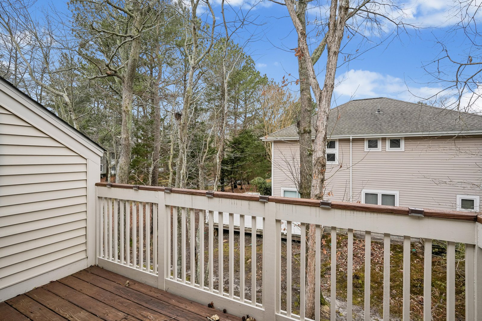 Step onto your private deck and breathe in the fresh air as sunlight filters through towering trees, creating a peaceful retreat where you can unwind and connect with nature.