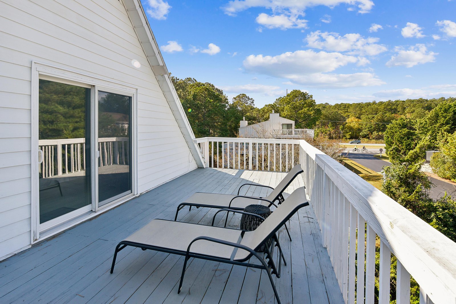 Relax on your private balcony with stunning views of surrounding trees and neighborhood. Perfect spot to unwind with morning coffee or evening sunset watching.