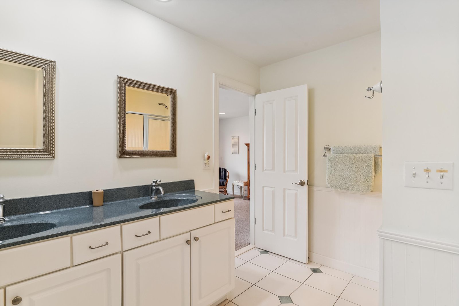 Step into your private ensuite with its dual vanity, sleek countertops, and soft towels at the ready—your perfect retreat after a busy day.