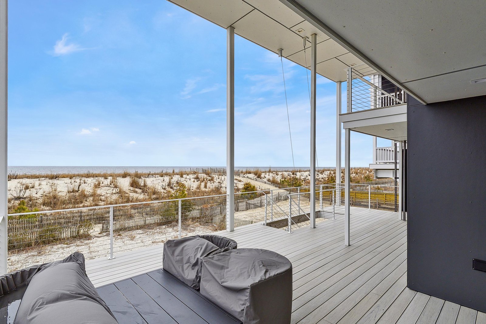Step out onto your private balcony and take in the stunning ocean views just beyond the sandy dunes, with the horizon stretching endlessly before you.