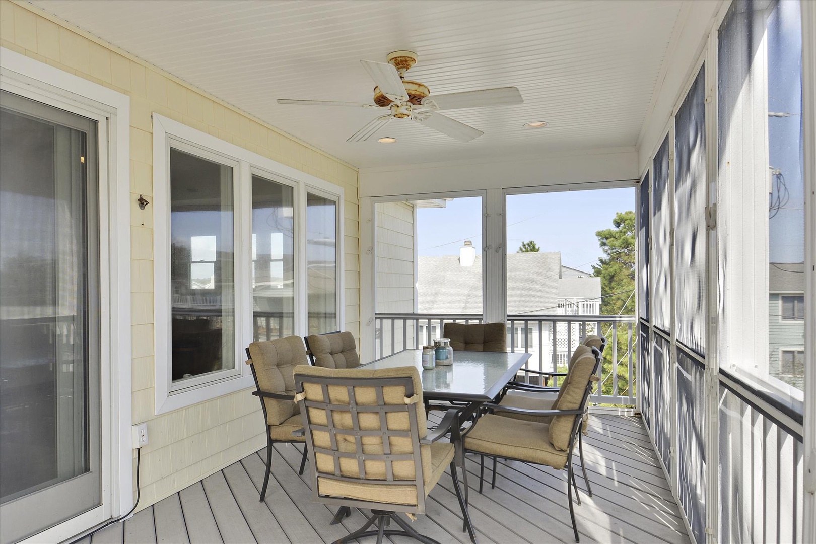 Relax on your covered porch with comfortable seating and ceiling fan while enjoying the neighborhood view.