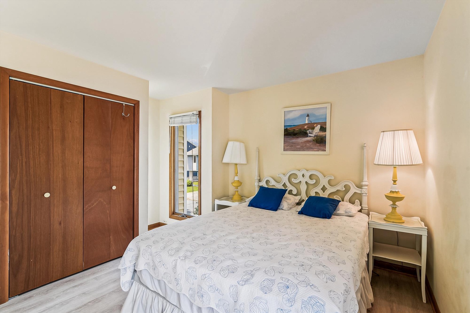 Relax in your peaceful bedroom with coastal-inspired décor, plush bedding, and warm lamplight that creates the perfect retreat after a day exploring the area.