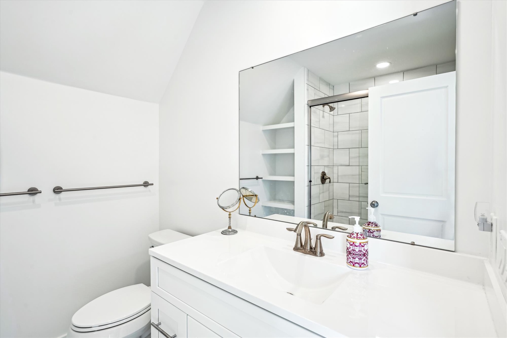 Step into your bright, modern bathroom with sparkling white surfaces and a refreshing walk-in shower. Fresh linens and sleek fixtures await your arrival—unwind and refresh in style.