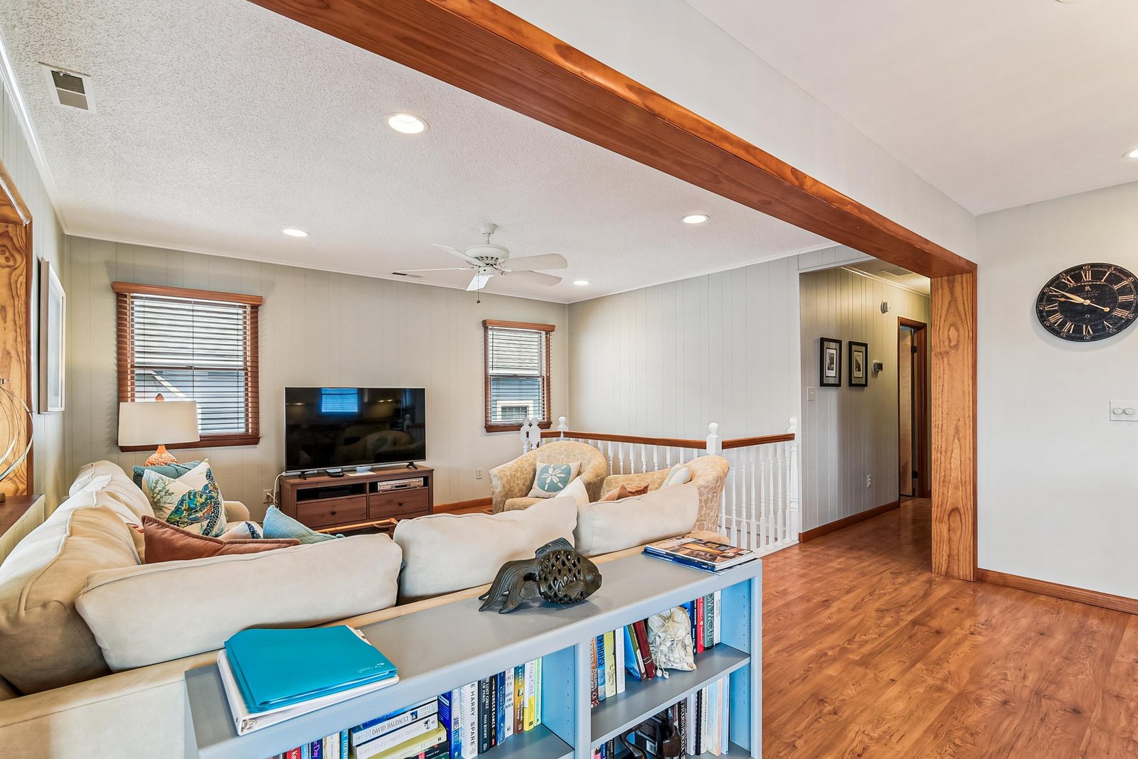 Settle into the bright living room with its charming wood beam accent, comfy sectional, and reading nook—your perfect spot to unwind after a day of exploring.
