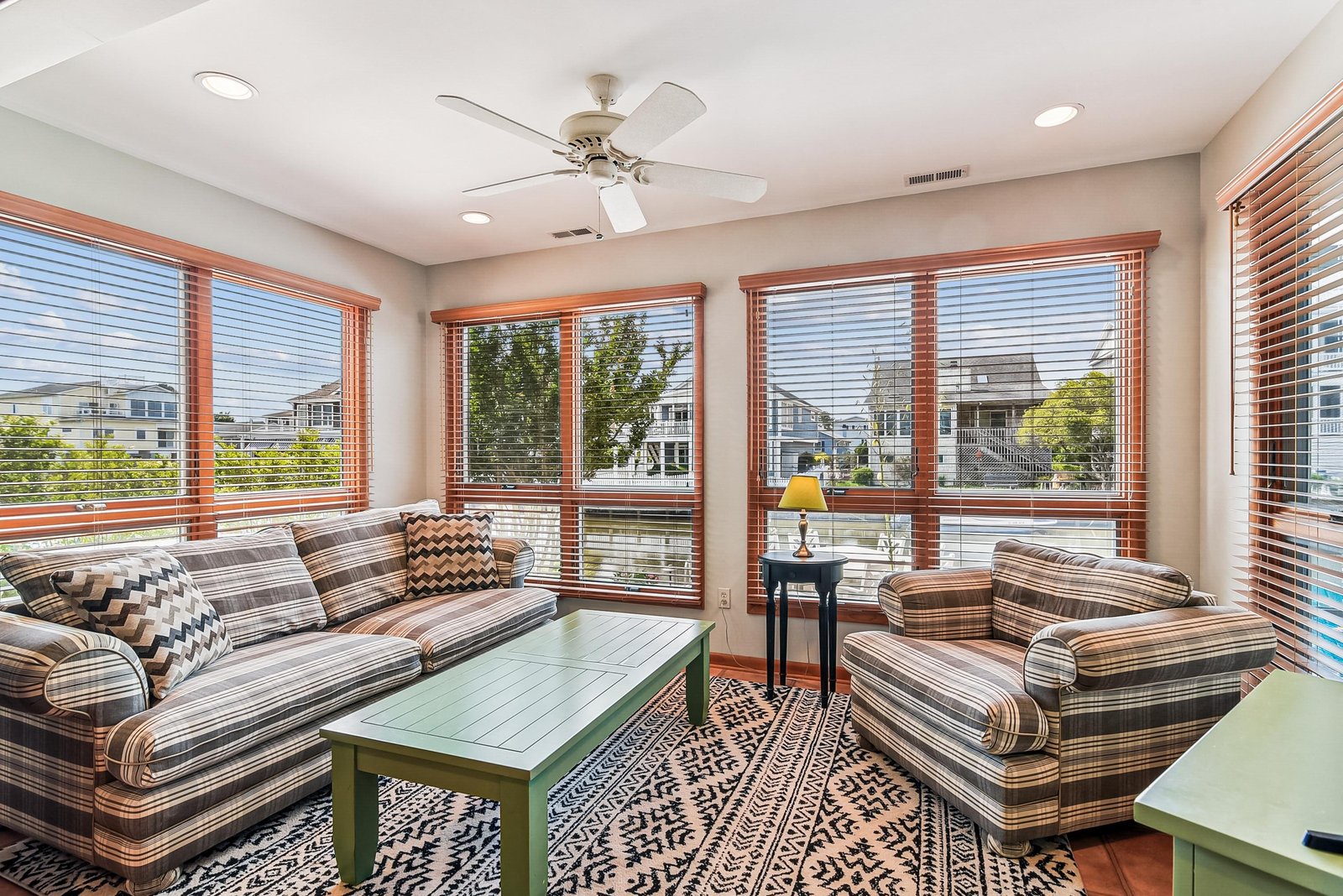 Step into your bright sunroom where neighborhood views and natural light create a perfect spot to unwind with a book or morning coffee.