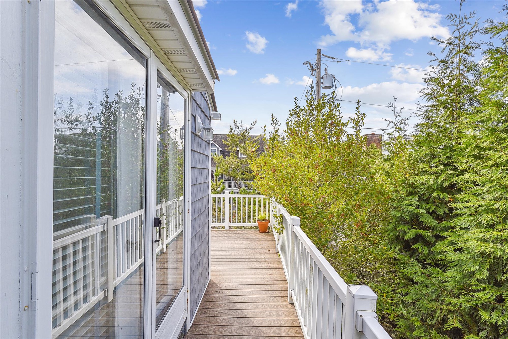 Private balcony surrounded by lush greenery where you can sip morning coffee or unwind beneath open skies after a day exploring nearby attractions.