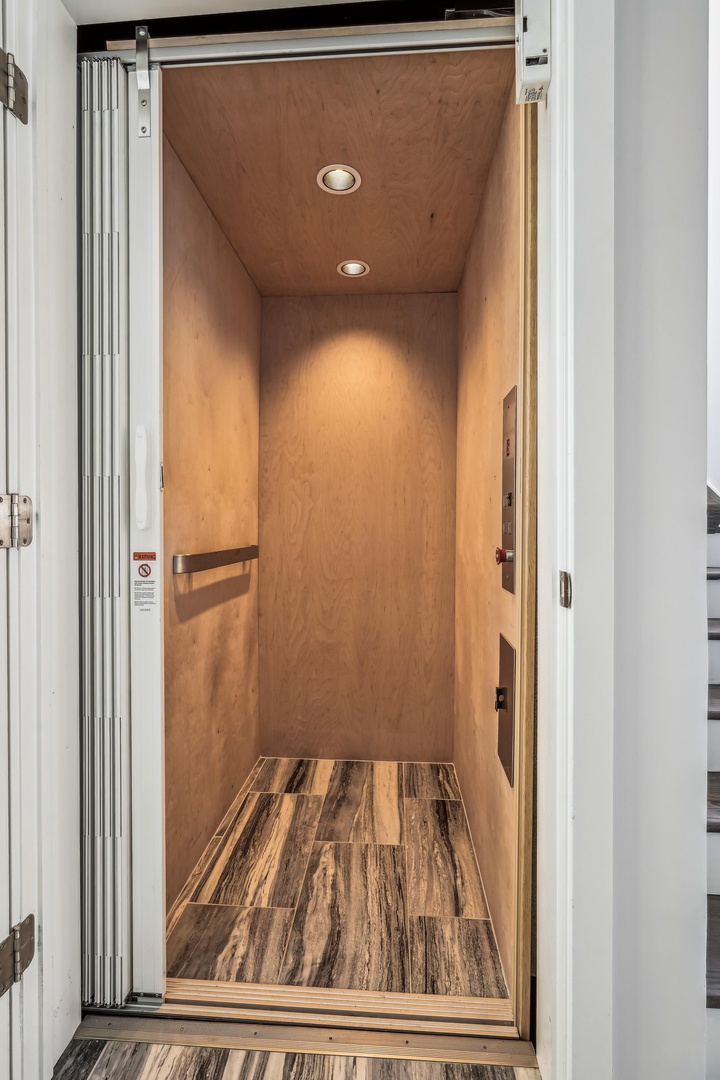 Step into your private home-away-from-home through a sleek, modern entrance with warm wood accents and thoughtful lighting that welcomes you inside.