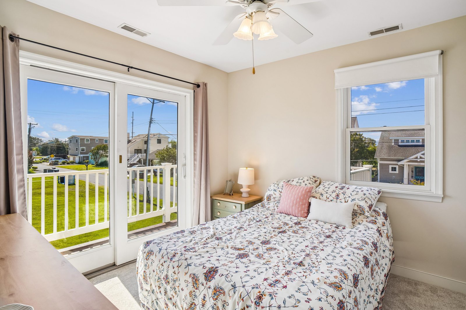 Wake up to fresh air and natural light in your cozy bedroom. A plush bed with charming linens and direct balcony access create your perfect retreat for relaxation.