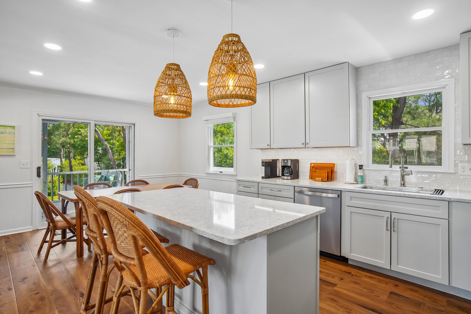 Step into a bright kitchen where natural light pours through picture windows, inviting you to gather around the spacious island for morning coffee or casual meals with loved ones.