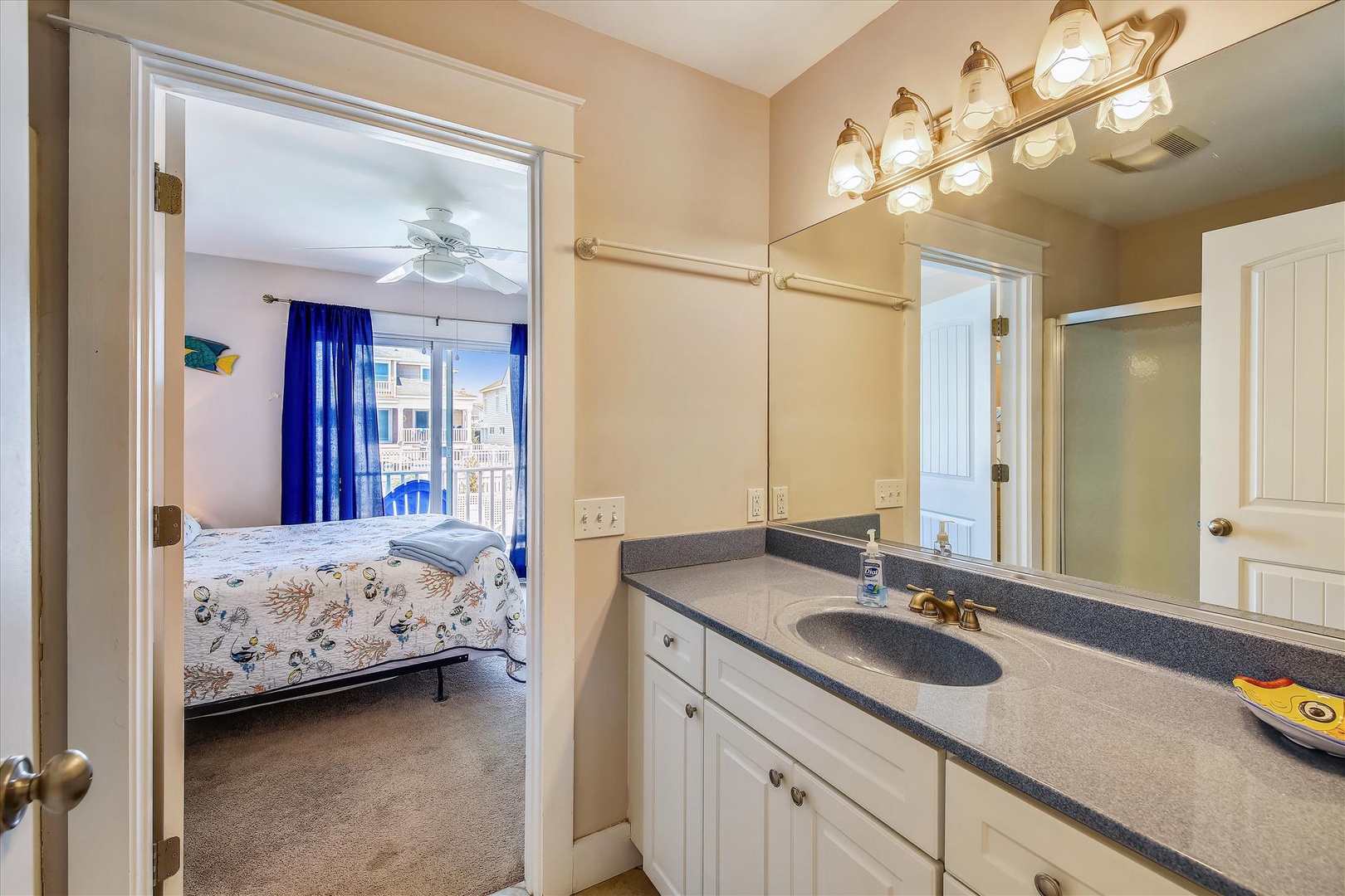 Your private bathroom awaits with a spacious vanity, bright lighting, and convenient access to your comfortable bedroom—perfect for unwinding after a day of adventures.