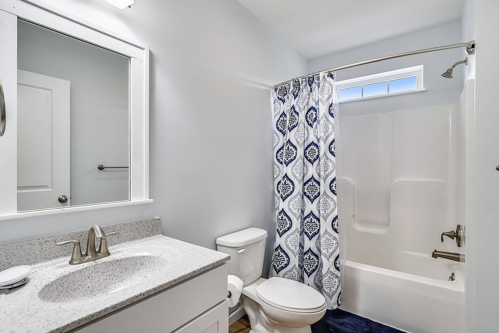 Step into your serene private bathroom, where soothing blue-gray tones and crisp white finishes invite you to unwind. Fresh towels await after a long day of exploring.