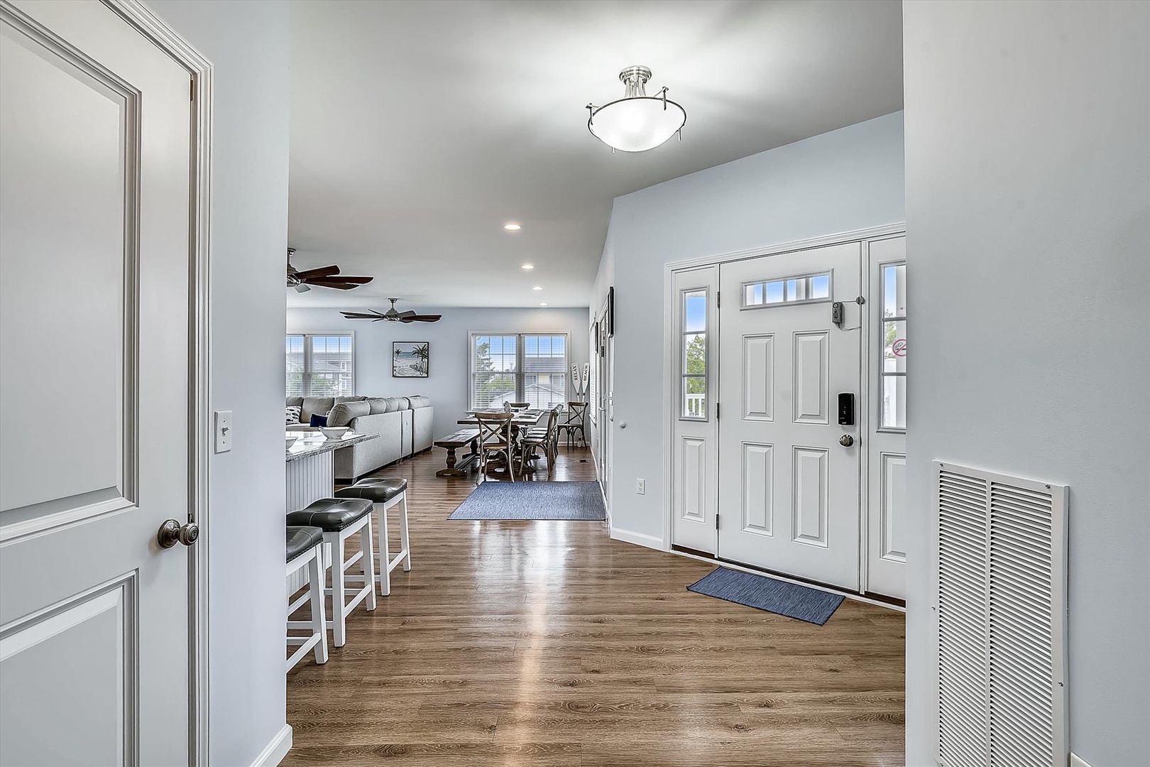 Step inside your airy, open-concept retreat where warm wood floors flow seamlessly from the welcoming entryway through to your sunlit living and dining spaces. You'll love the natural light and coastal breezes keeping you comfortable all day.