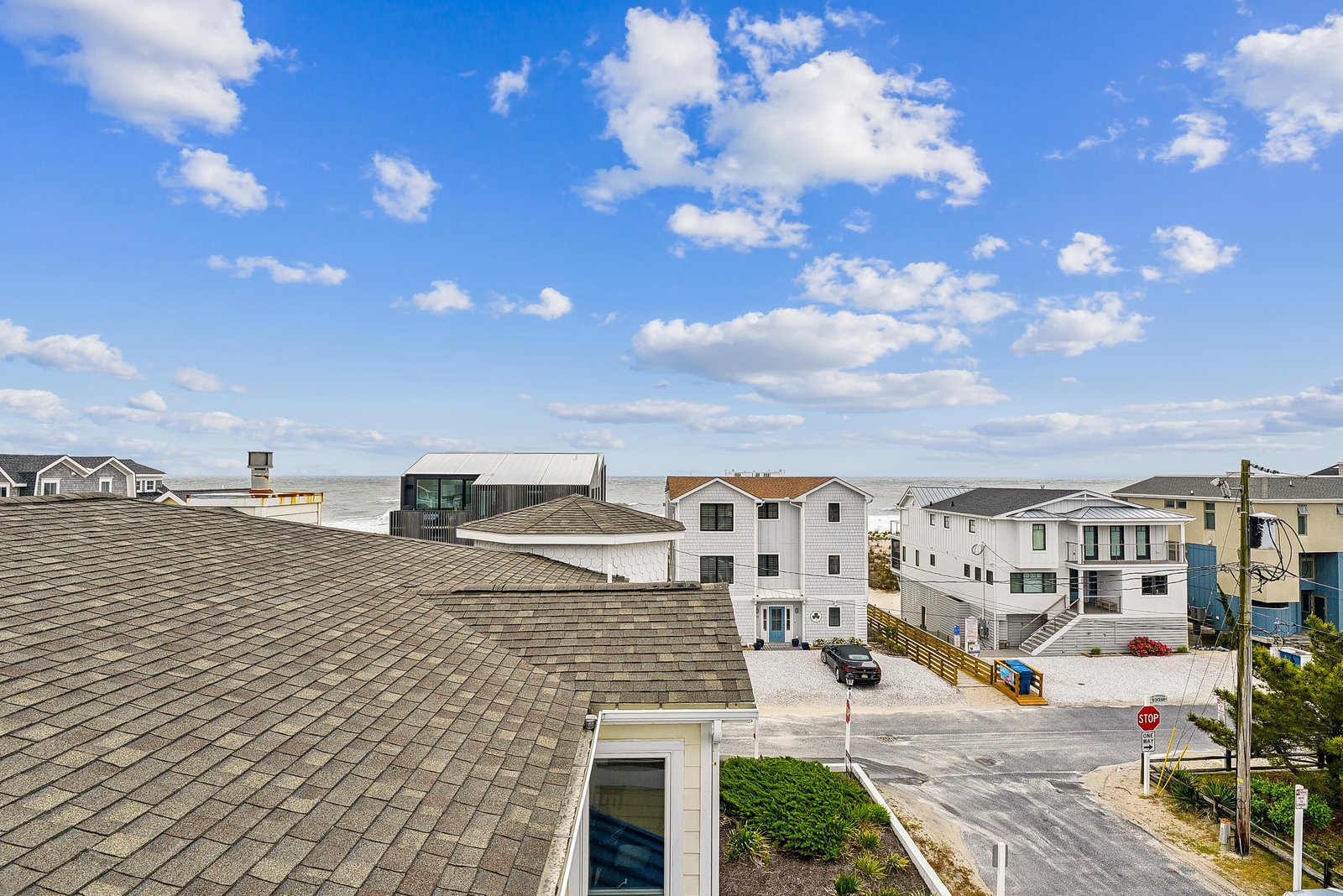 Coastal property situated in a quiet beach neighborhood with rooftop ocean views and nearby waterfront homes.