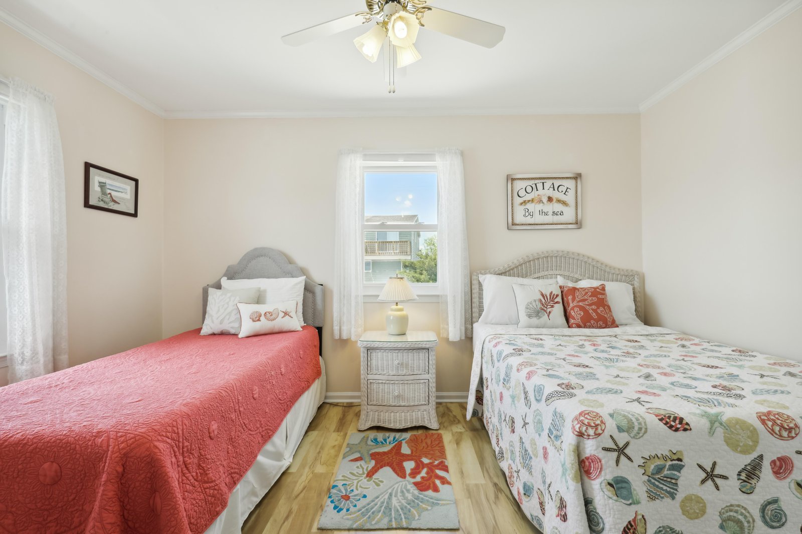 Wake to gentle coastal breezes in your inviting bedroom, where two comfortable beds promise restful nights and cheerful mornings by the sea.