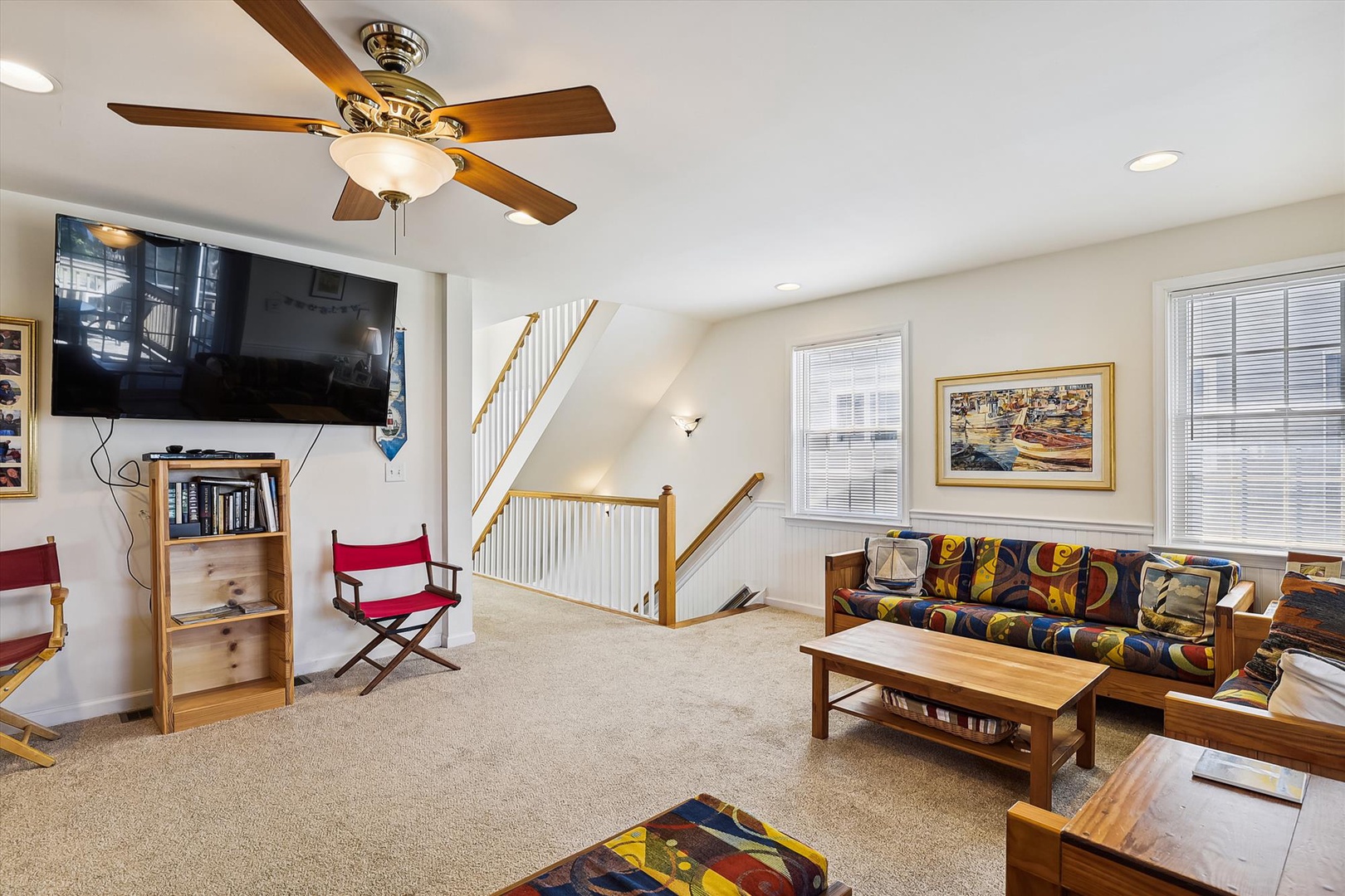 Unwind in this bright, spacious living area with cozy seating, a large TV for your entertainment, and a ceiling fan to keep you comfortable throughout your stay.