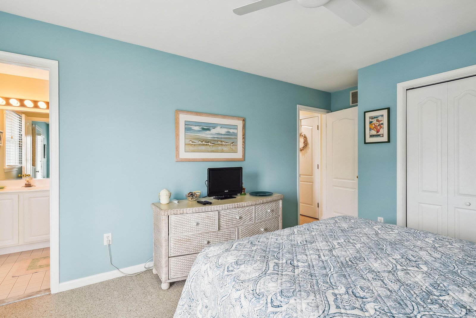 Drift into restful sleep in this calming coastal bedroom, where soft blue walls and beachy décor invite your most relaxing getaway yet.