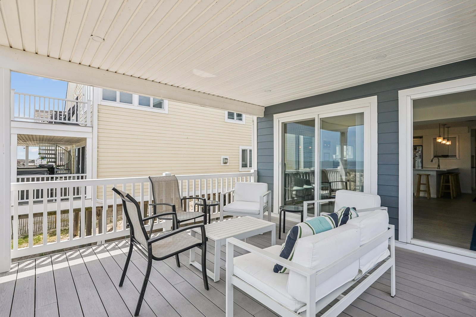 Step outside to your private covered deck, where crisp white furniture and coastal breezes invite you to unwind with your morning coffee or watch the day drift by.
